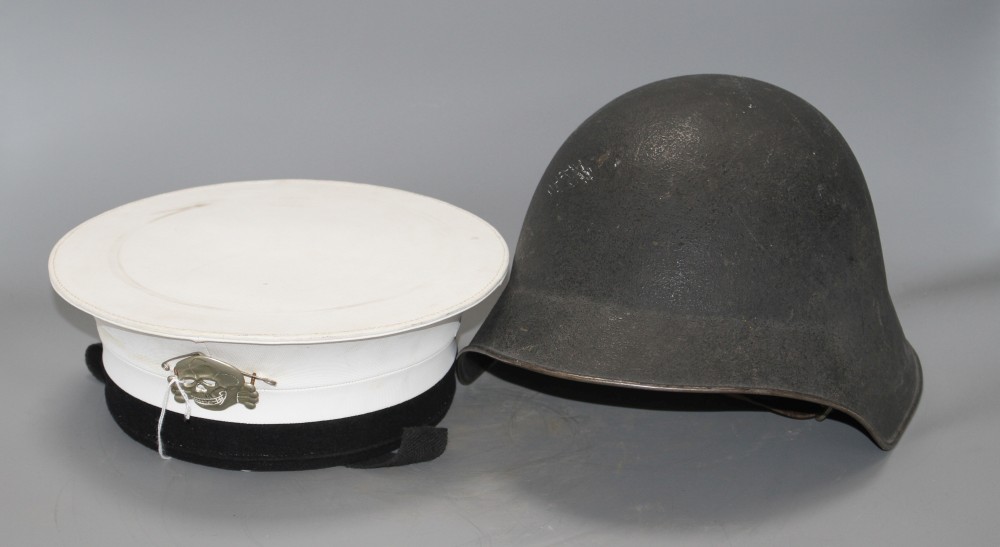 A Russian sailors cap with numbered label and attached skull and crossbones badge, and a steel helmet with original leather fittings